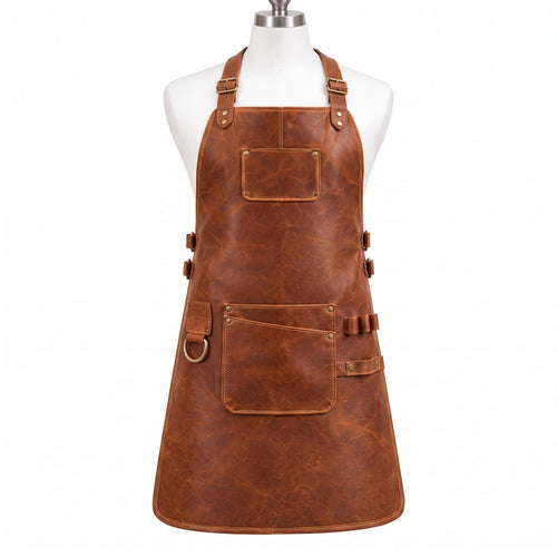 "Brown distressed leather work apron with adjustable neck strap, brass buckles, front pocket with pen slot, side pocket, and D-ring, displayed on a mannequin against a white background."