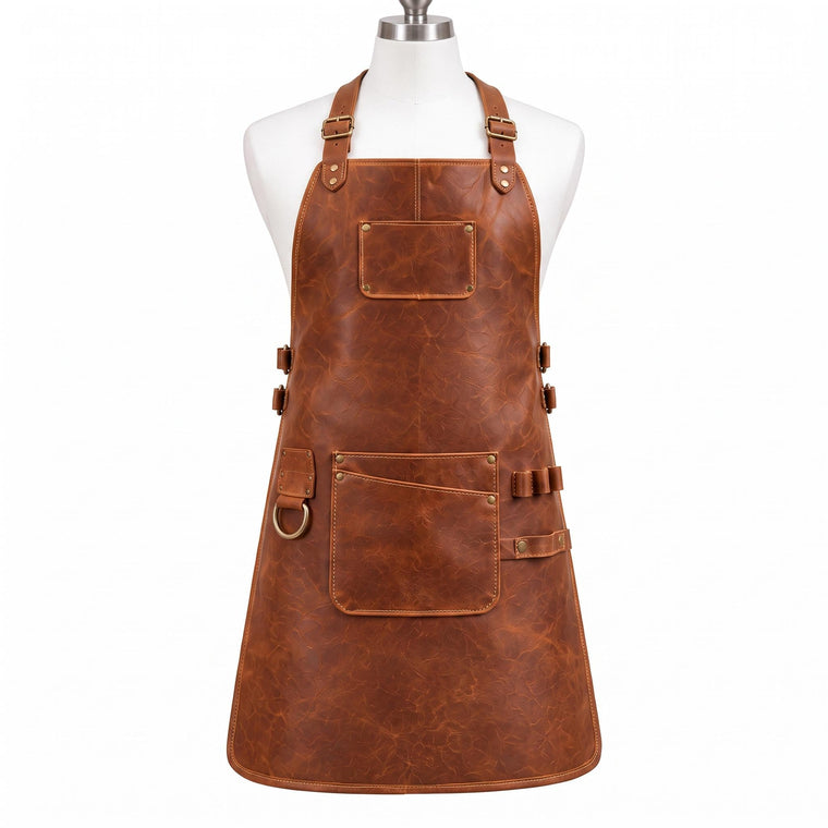 "Brown distressed leather work apron with adjustable neck strap, brass buckles, front pocket with pen slot, side pocket, and D-ring, displayed on a mannequin against a white background."