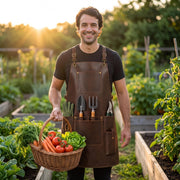 "Smiling man wearing brown leather gardening apron with tool pockets, holding a basket of fresh vegetables in a sunlit garden at golden hour."