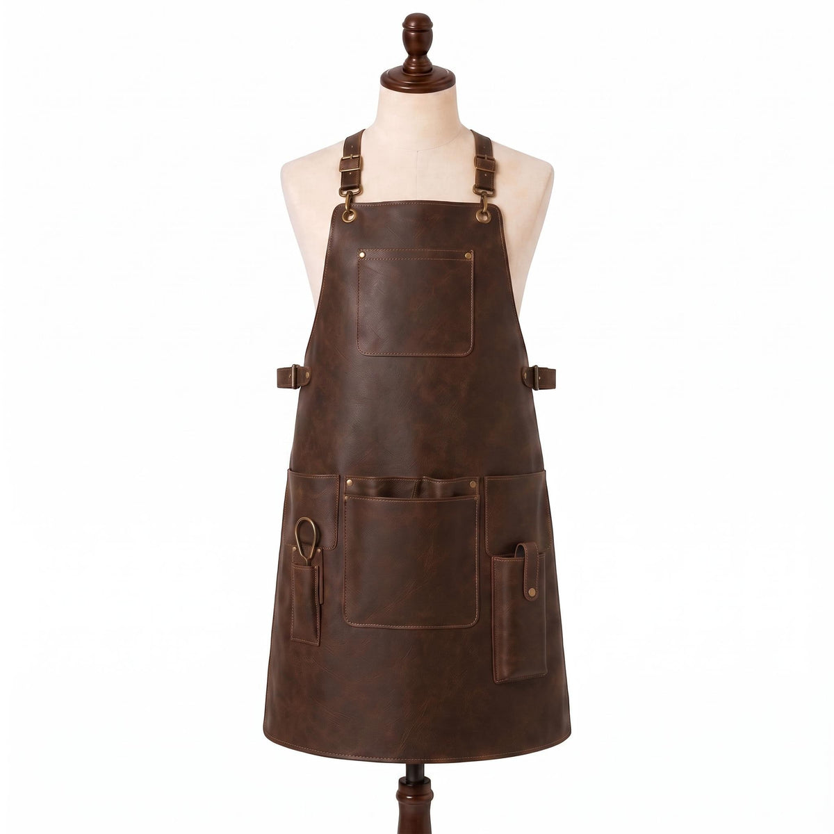 "Distressed brown leather apron with adjustable buckle straps, front chest pocket, waist pockets, and a scissor/tool loop, displayed on a mannequin against a white background."
