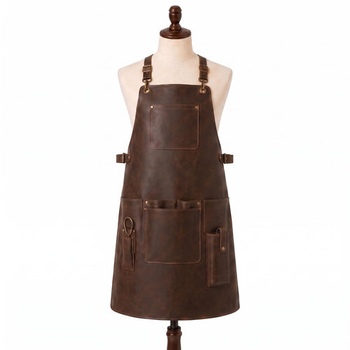 "Distressed brown leather apron with adjustable buckle straps, front chest pocket, waist pockets, and a scissor/tool loop, displayed on a mannequin against a white background."