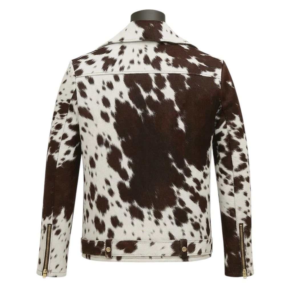 "Back view of a cowhide print leather biker jacket displayed on a black mannequin, featuring gold zippers on the sleeves, on a soft cream-colored background.")