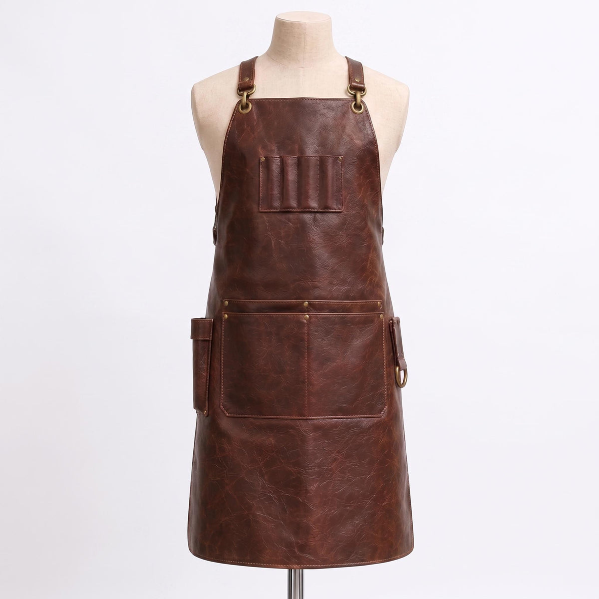 "Empty brown distressed leather barber apron with multiple pockets, shown on a mannequin, no tools inside."