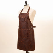 Side view of brown full-grain leather apron with adjustable buckle straps, front chest pocket, and large lower tool pocket, displayed on mannequin