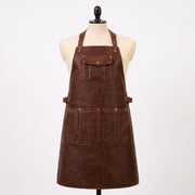 Brown leather BBQ apron with adjustable straps, waist belt, brass hardware and multiple utility pockets on mannequin.