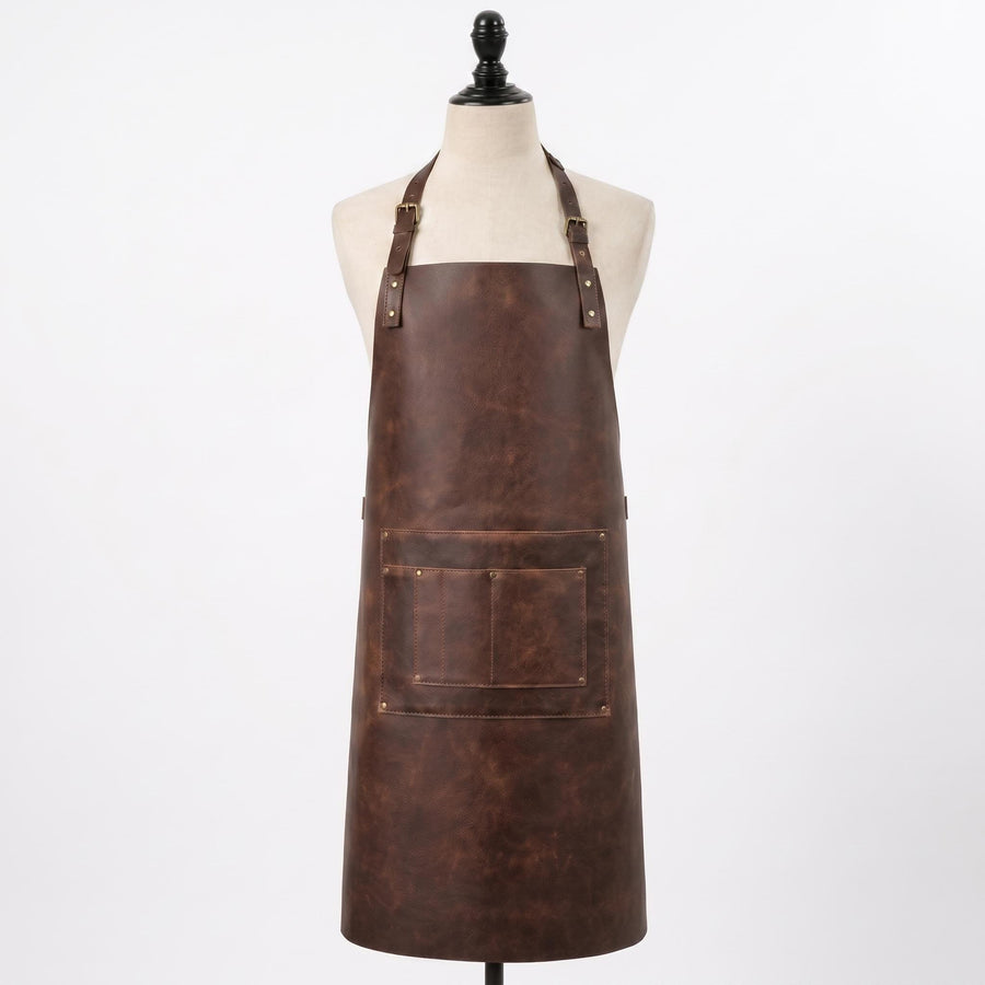 "Brown distressed leather apron with front pocket, displayed on a mannequin against a white background."
