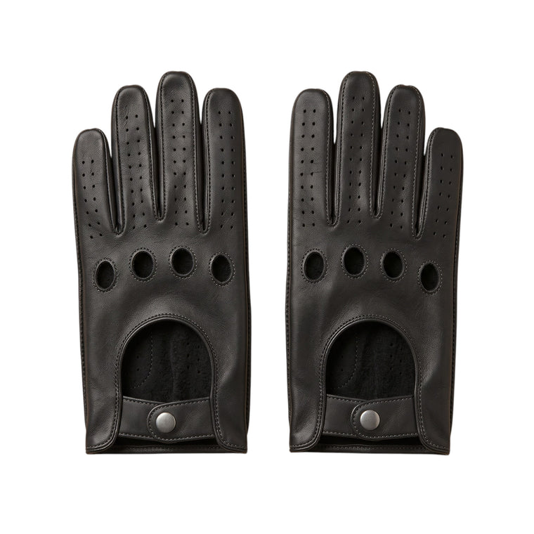 "A pair of black leather driving gloves laid flat side by side, each showing four circular ventilation holes, perforated fingers, and a snap-button wrist strap on a white background."