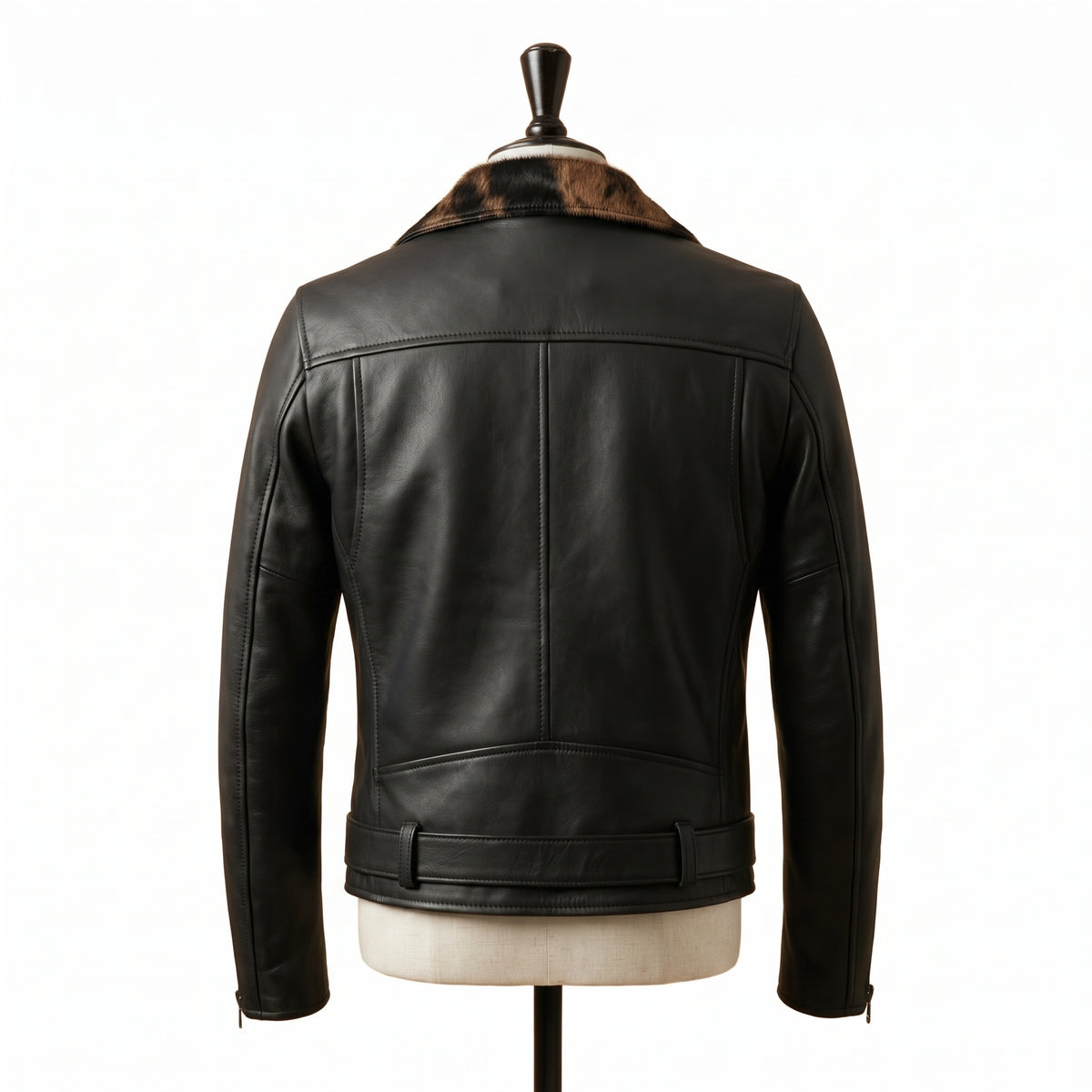 "Front view of a black leather biker jacket with animal-print fur lapel panel, zip pockets, belted waist, and asymmetric front zipper, displayed on a mannequin against a white background."