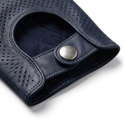 **"Close-up of navy leather glove's wrist snap button closure"**