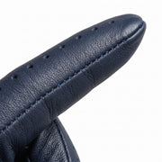 **"Close-up of navy blue leather glove finger with perforated stitching"**