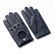 A pair of navy blue leather driving gloves, one showing the perforated back of the hand with ventilation holes and a snap closure, and the other showing the quilted palm and textured back of the hand, set against a plain white background.