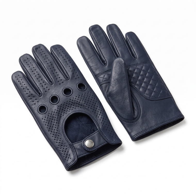 A pair of navy blue leather driving gloves, one showing the perforated back of the hand with ventilation holes and a snap closure, and the other showing the quilted palm and textured back of the hand, set against a plain white background.