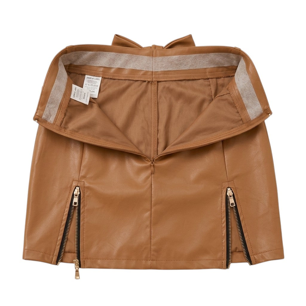 "Interior construction view of brown faux leather mini skirt showing waistband lining, care and size label tags, back zipper closure, and dual front zipper hem details."