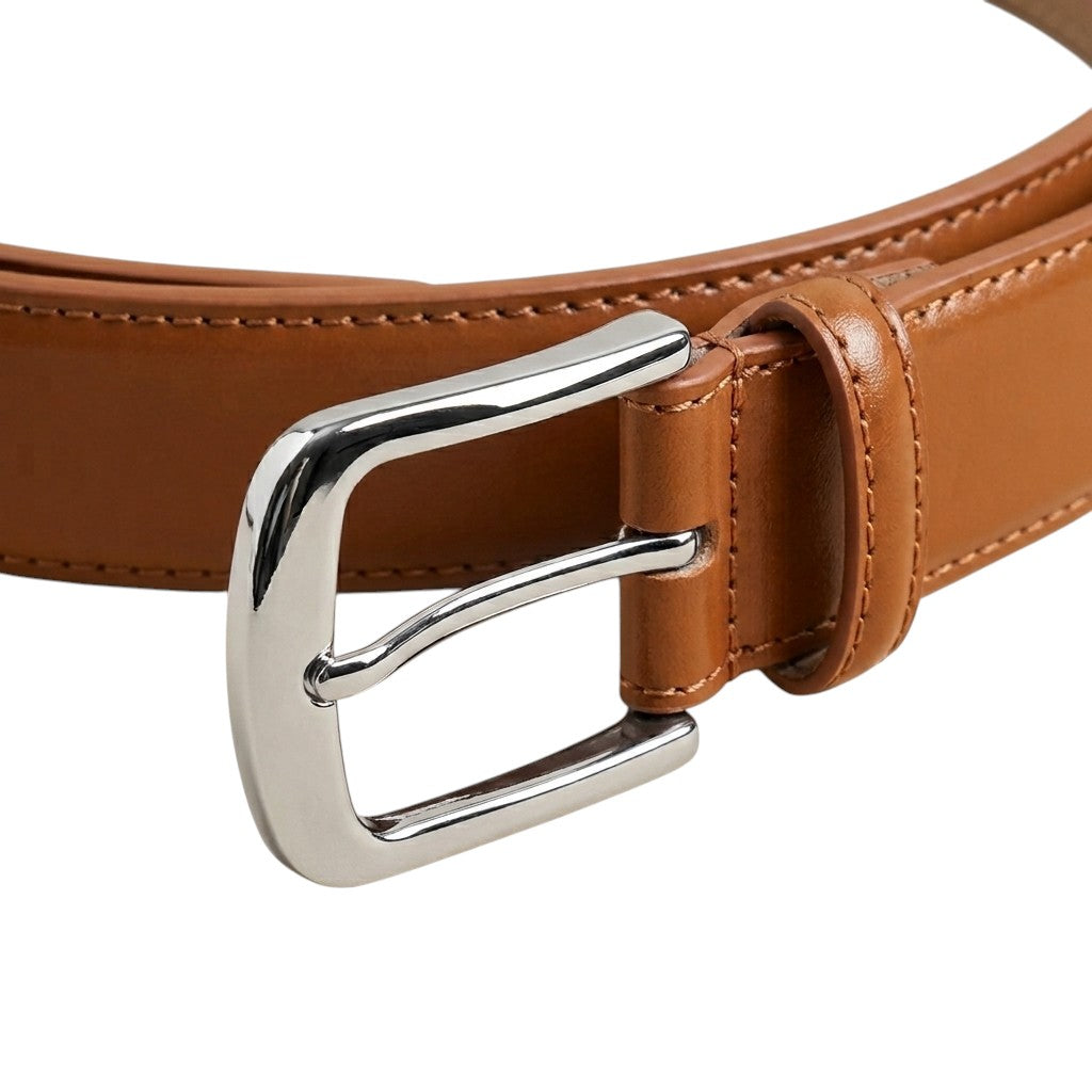 "Close-up of glossy chrome buckle on tan leather belt with double loop and stitching"