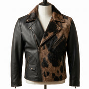 A black leather biker jacket with a brown and black cowhide-patterned fur collar and front panel, displayed on a cream mannequin torso against a white background.