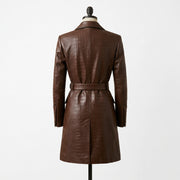 "Back view of a brown crocodile-embossed leather coat with notch lapel, belted waist, and back vent, displayed on a mannequin against a white background."
