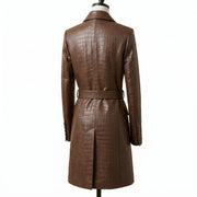 A brown crocodile-embossed leather trench coat displayed on a mannequin from the back view, featuring a matching belt at the waist.