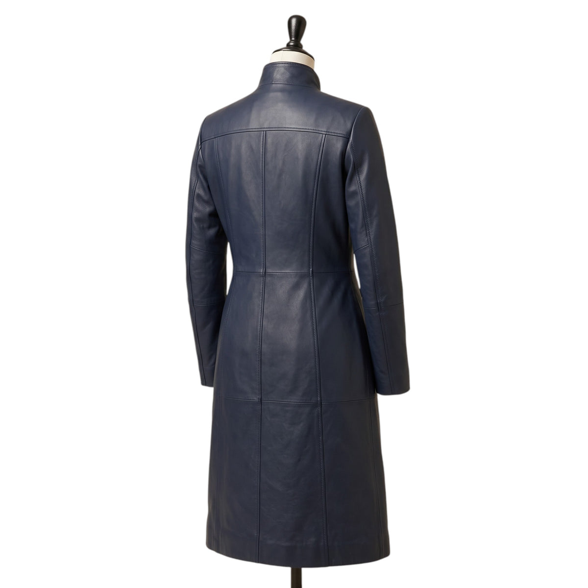 "Angled back view of a navy blue leather coat with a stand collar and fitted A-line silhouette, displayed on a mannequin against a white background."