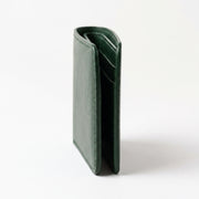 A dark green leather bifold wallet standing upright on a clean white background.