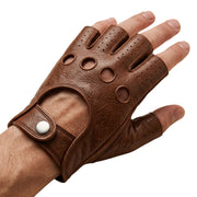 "A hand wearing a brown leather fingerless driving glove with open fingertips, circular ventilation holes on the knuckle area, and a snap-button wrist strap, photographed on a white background."