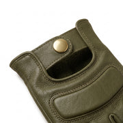 **"Close-up of olive leather motorcycle glove's wrist snap closure"**