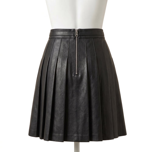 "Back view of the black leather pleated mini skirt on a mannequin, showing a center back zipper closure and full box pleats against a white background."