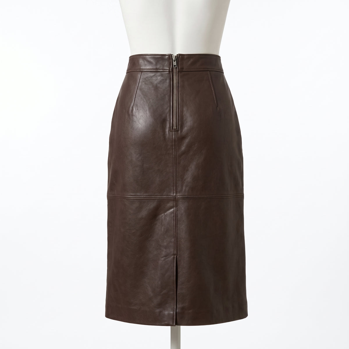 "Back view of the dark brown leather pencil skirt on a mannequin, showing a full-length center zipper closure and horizontal seam against a light background."