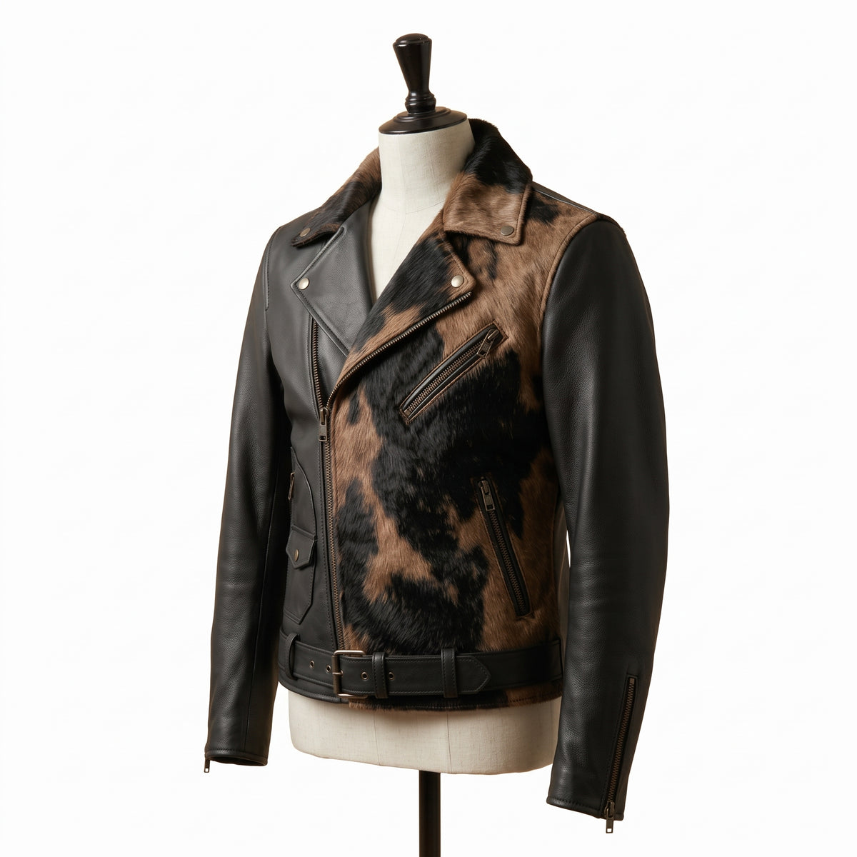 "Angled view of a black leather biker jacket with animal-print fur lapel panel, zip pockets, and belted waist, displayed on a mannequin against a white background."