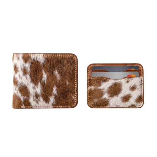 "Closed cow-print (brown and white) leather bifold wallet on the left, and a matching cow-print card holder with credit cards tucked inside on the right, both photographed on a white background."