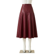 Back view of a maroon faux leather A-line midi skirt showing a centered zipper closure and paneled seams, displayed on a headless mannequin against a white background."