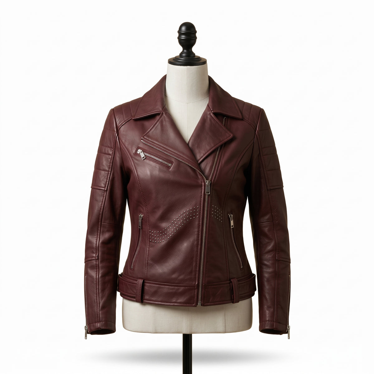 "Front view of a maroon leather biker jacket with asymmetric front zipper, notch lapel, multiple zip pockets, and stud detailing, displayed on a mannequin against a white background."