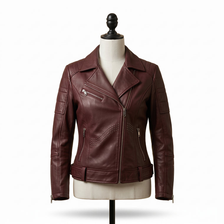 "Front view of a maroon leather biker jacket with asymmetric front zipper, notch lapel, multiple zip pockets, and stud detailing, displayed on a mannequin against a white background."
