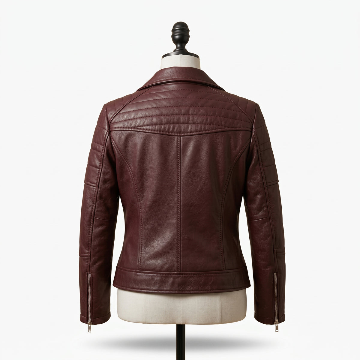 "Back view of a maroon leather motorcycle jacket with notch lapel collar, quilted shoulder detailing, and side zippers, displayed on a mannequin against a white background."