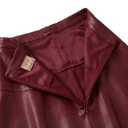 "Close-up of a maroon faux leather skirt's waistband, unzipped to show satin lining, interior brand label, and hook-and-eye closure detail."