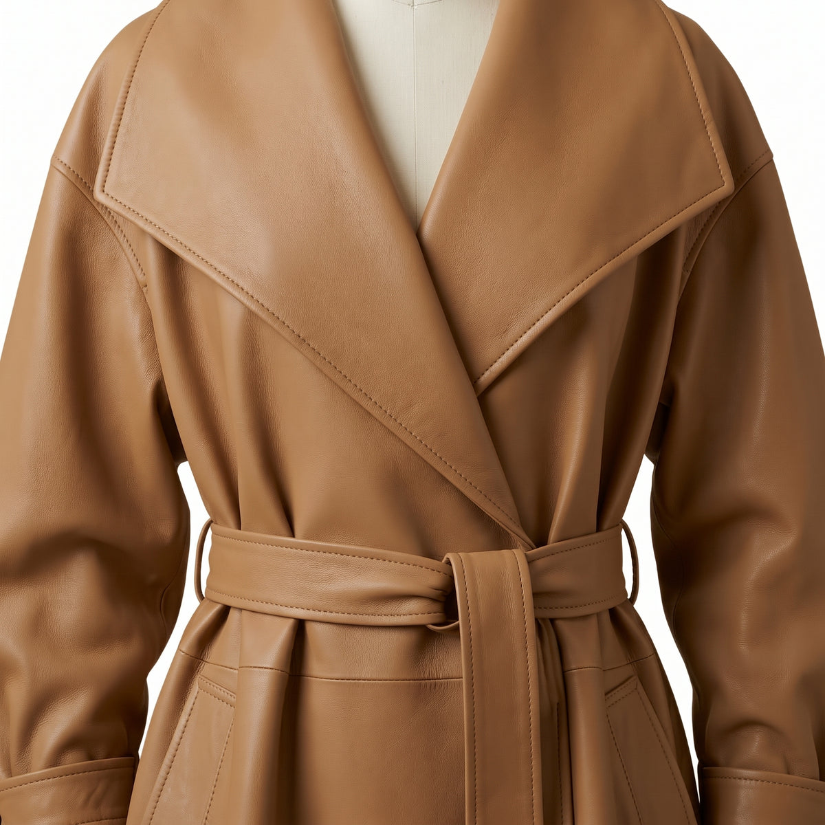 "Close-up detail of a tan leather trench coat's oversized shawl collar and tied waist belt."