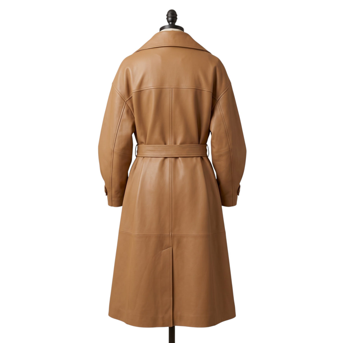 "Back view of a tan leather trench coat with belted waist, wide collar, and cuffed sleeves, displayed on a mannequin against a white background."