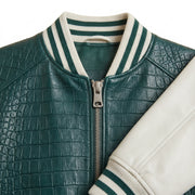 **"Close-up of green croc-embossed varsity jacket's collar and zipper"**