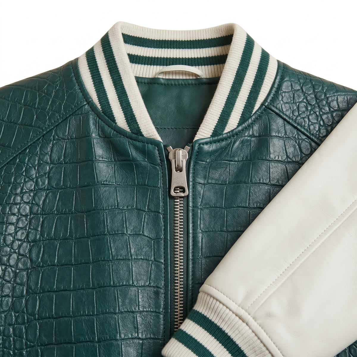 **"Close-up of green croc-embossed varsity jacket's collar and zipper"**