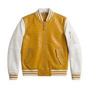 A yellow crocodile-embossed leather varsity jacket with white leather sleeves, featuring a front zipper, zippered hand pockets, and striped ribbed collar, cuffs, and hem.