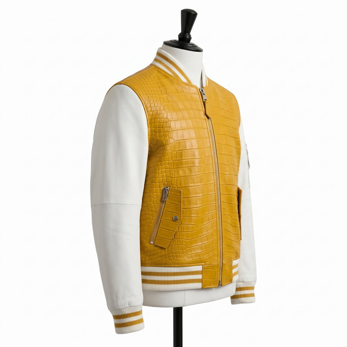 A yellow crocodile-embossed faux-leather bomber jacket with white sleeves, displayed on a mannequin against a white background.