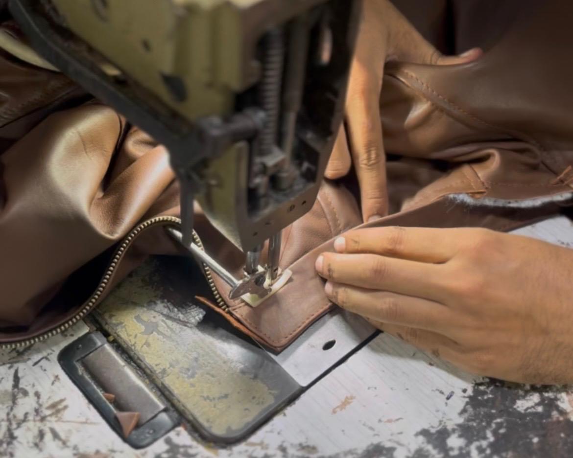 Leather product being stitched during bulk production