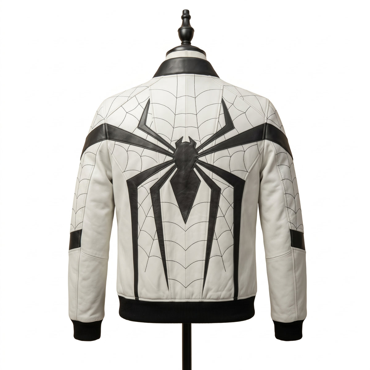 "Back view of a white leather bomber jacket with black web-pattern stitching and a large black spider graphic across the back, black ribbed collar and cuffs, displayed on a mannequin against a white background."