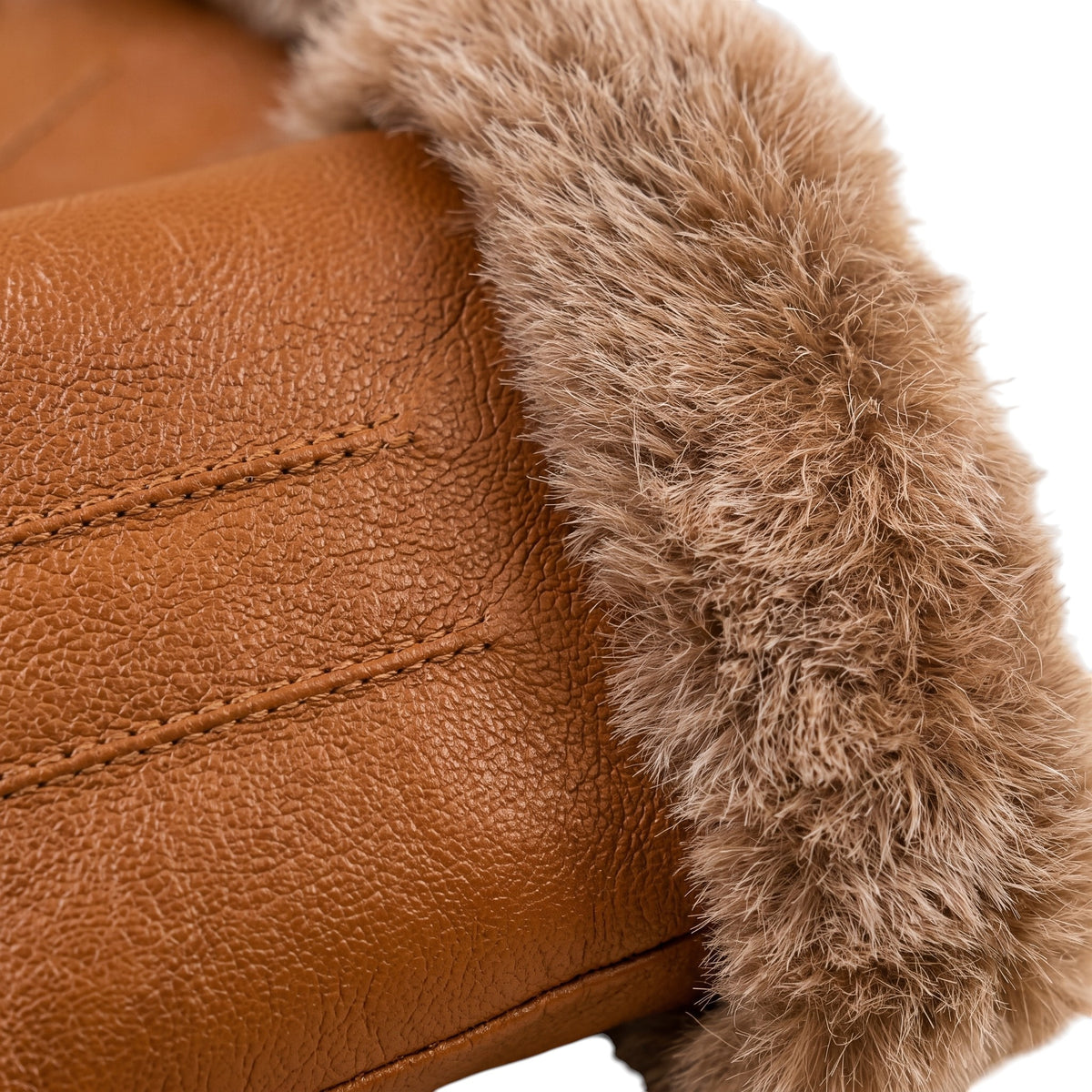 Close-up of a tan leather boot or glove with a thick brown faux-fur trim, showing the texture of both materials against a white background.