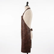 Side view of a brown leather apron with a side pocket, displayed on a mannequin."