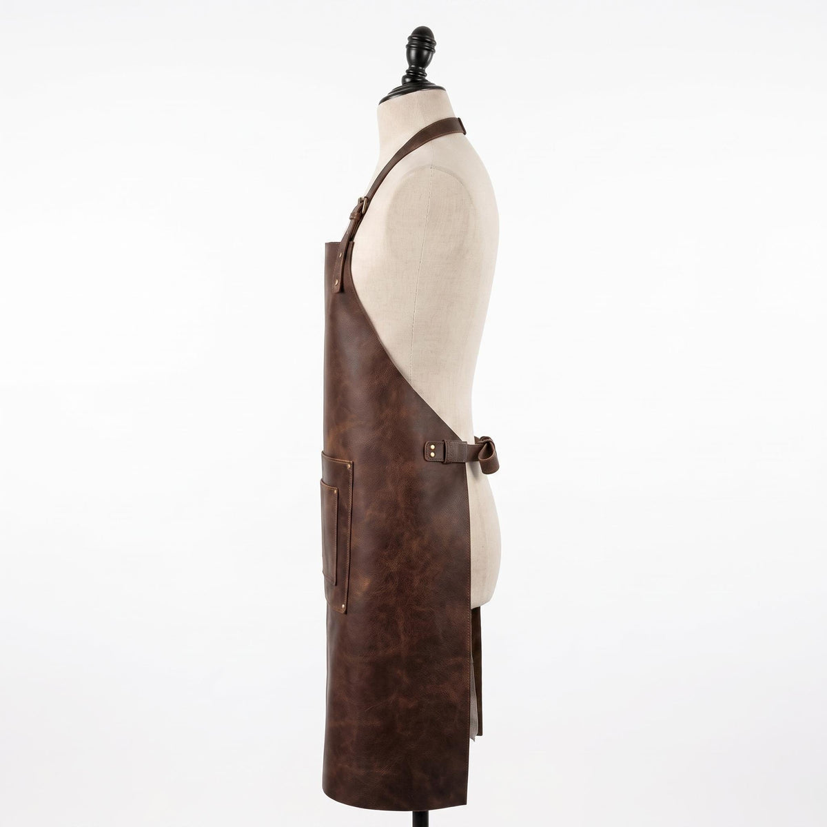 Side view of a brown leather apron with a side pocket, displayed on a mannequin."
