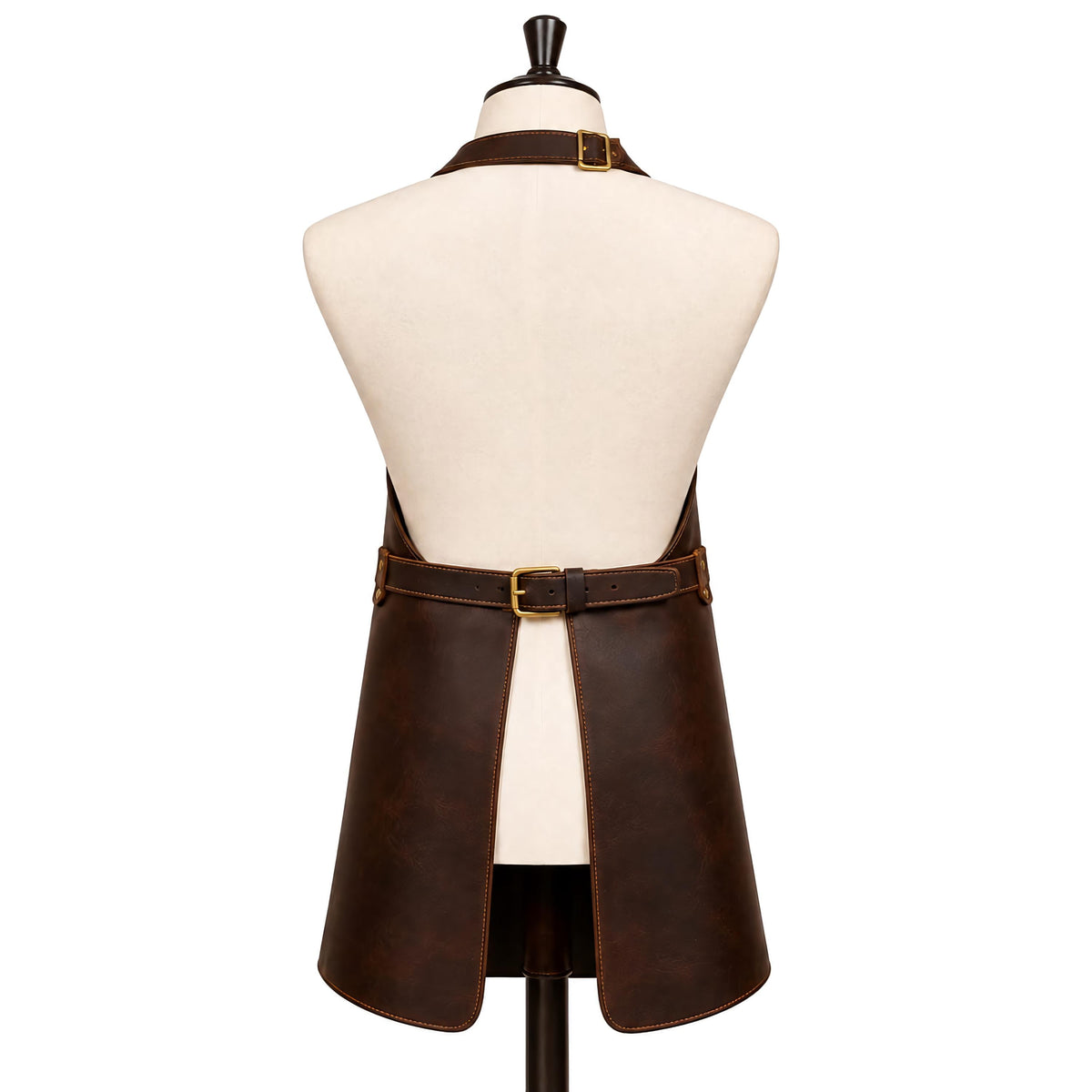 "Back view of a dark brown leather apron on a cream mannequin torso, showing an adjustable neck strap with brass buckle, a wide waist belt with brass buckle closure, and a split lower panel forming two hanging leather straps, set against a plain white background."