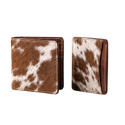 "Standing cow-print (brown and white) leather bifold wallet on the left, and a matching card holder wallet on the right, both photographed at a slight angle on a white background."