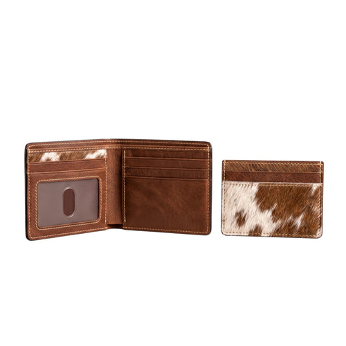 "Open brown leather bifold wallet with card slots and ID window on the left, and a matching cow-print (brown and white) card holder wallet on the right, both photographed on a white background."