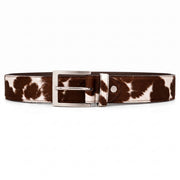 "Brown and white cow-print calf hair leather belt with a silver-tone metal buckle, laid flat on a white background."
