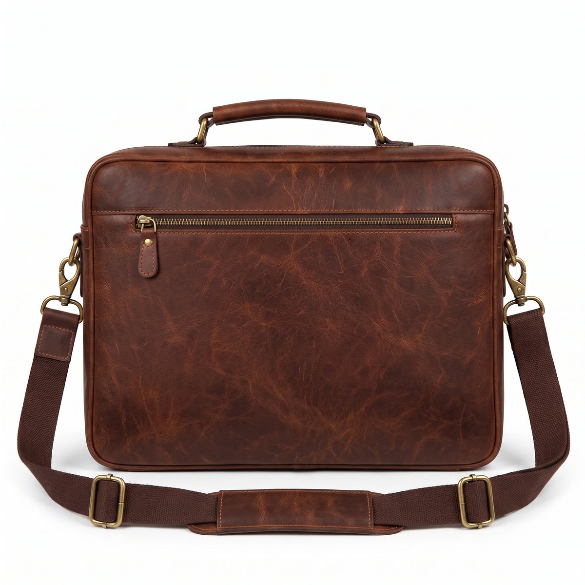 "Back view of the brown leather briefcase showing a zippered slip pocket with a brass zipper pull and the adjustable shoulder strap draped across the front, photographed on a white background."